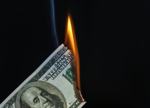 $100 bill on fire