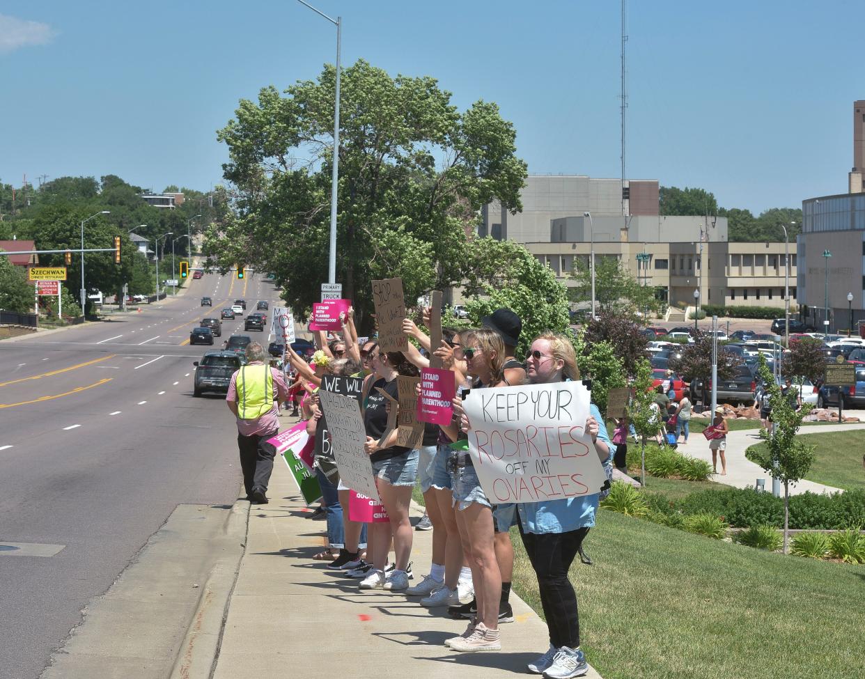 People stand on Minnesota Avenue after a rally for abortion rights in Sioux Falls on Sunday, July 10, 2022.