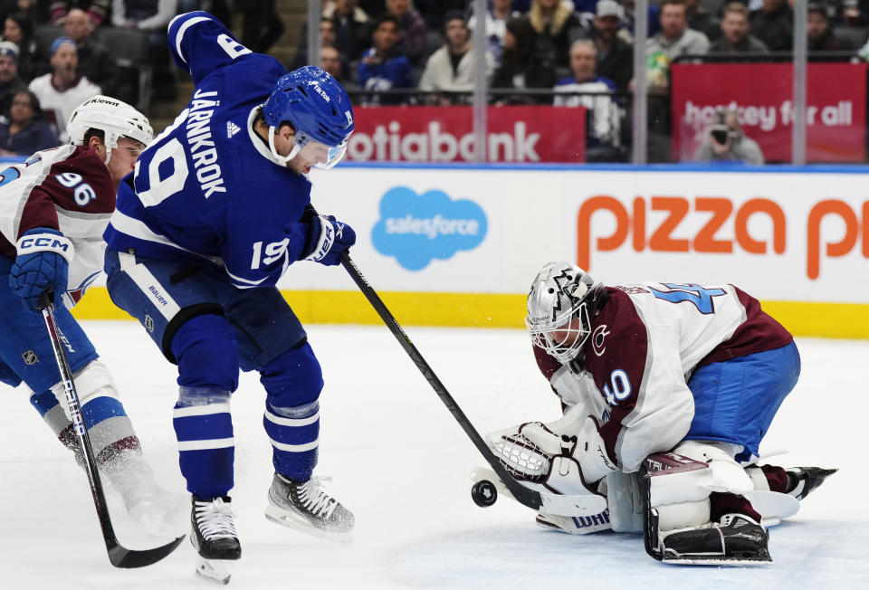 Toronto Maple Leafs' Calle Jarnkrok (19) is stopped by Colorado Avalanche goaltender Alexandar Georgiev (40) as Mikko Rantanen (96) defends during the second period of an NHL hockey game Wednesday, March 15, 2023, in Toronto. (Frank Gunn/The Canadian Press via AP)