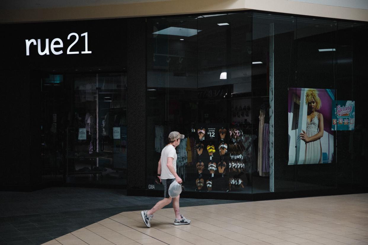 A person walking by a Rue21 store in South Carolina.