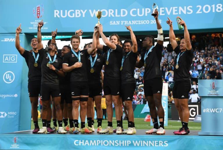 Members of New Zealand's team celebrate with their medals and trophy after defeating England, 33-12, in the Rugby Sevens World Cup Final, at the AT&T Park in San Francisco, California, on July 22, 2018