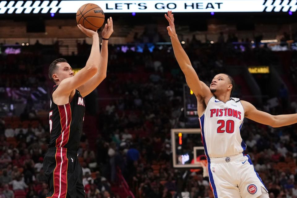 Heat forward Duncan Robinson shoots the ball over Pistons forward Kevin Knox II during the first half on Tuesday, Dec. 6, 2022, in Miami.