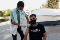 A nurse gives a shot of the Pfizer COVID-19 vaccine to a youth at a temporary clinic tents at the Unknown soldier square in Gaza City, in Gaza City, Thursday, Sept. 23, 2021. (AP Photo/Adel Hana)