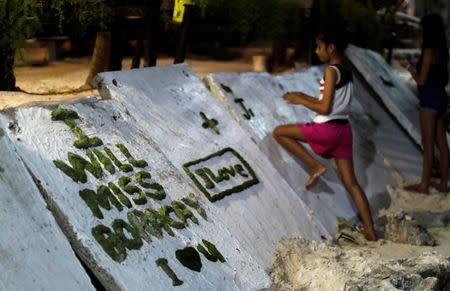 A girl scribbles on a wall two days before the temporary closure of the holiday island Boracay, in the Philippines April 24, 2018. REUTERS/Erik De Castro