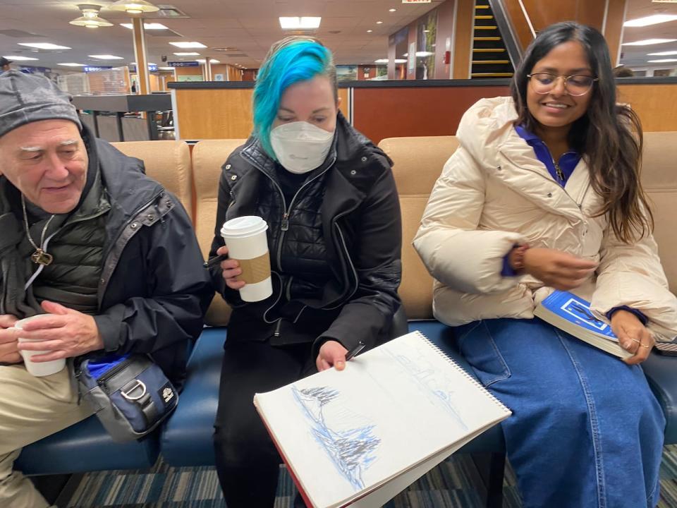 Alina Pete in the middle showing a picture she drew while on a trip to Bute Inlet, B.C. 