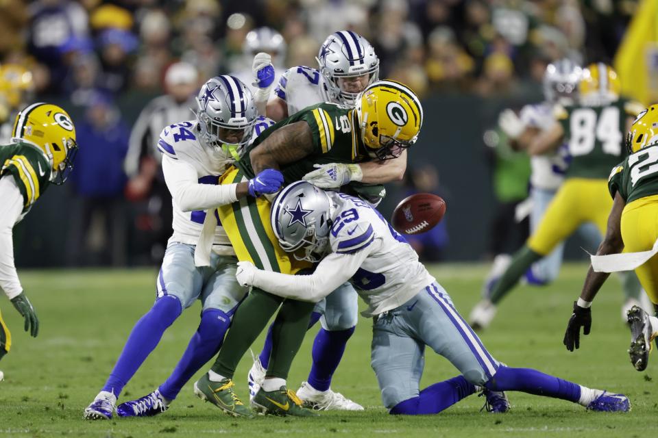Green Bay Packers wide receiver Amari Rodgers (8) fumbles a punt return after being hit by Dallas Cowboys' Israel Mukuamu (24), C.J. Goodwin (29) and Luke Gifford, rear, during the second half of an NFL football game Sunday, Nov. 13, 2022, in Green Bay, Wis. (AP Photo/Matt Ludtke)