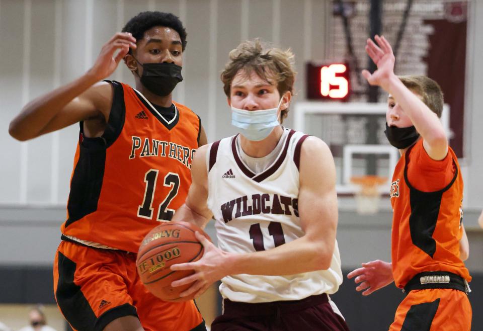 West Bridgewater's Ryan Hulme drives the lane past Avon defenders from left, Tom Irby and Nate Maguire during a game on Wednesday, Jan. 19, 2022.  