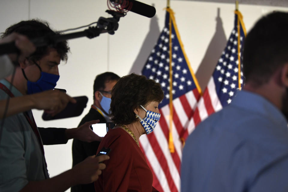 FILE - In this June 9, 2020, file photo Sen. Susan Collins, R-Maine, is followed by reporters as she arrives for the weekly Republican policy luncheon on Capitol Hill in Washington. Collins, who is in the reelection fight of her life, “was at work in Washington” recently as President Donald Trump visited her state to open a marine conservation area to commercial fishing. The Senate wasn't in session that day. (AP Photo/Susan Walsh, File)