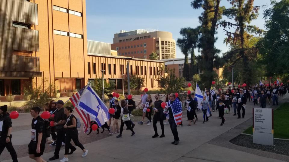 A crowd marches during a rally Sunday, Dec. 3, 2023 at Hayden Lawn at Arizona State University in Tempe. Marchers walked in support of releasing Hamas hostages.