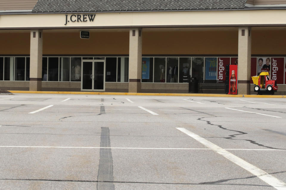 An empty parking is visible outside the J.Crew store, closed due to the COVID-19 virus outbreak, in Tilton, New Hampshire, Monday, May 4, 2020. The owner of J.Crew is filing for bankruptcy protection, the first major retailer to do so since the pandemic forced the closing of most stores in the United States. More retail bankruptcies are expected in coming weeks with the doors of thousands of stores still locked. (AP Photo/Charles Krupa)