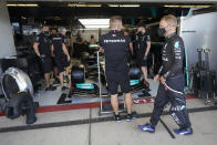 Mercedes driver Valtteri Bottas, of Finland, walks in front of his garage before a practice session for the F1 US Grand Prix auto race at the Circuit of the Americas, Friday, Oct. 22, 2021, in Austin, Texas. (AP Photo/Darron Cummings)