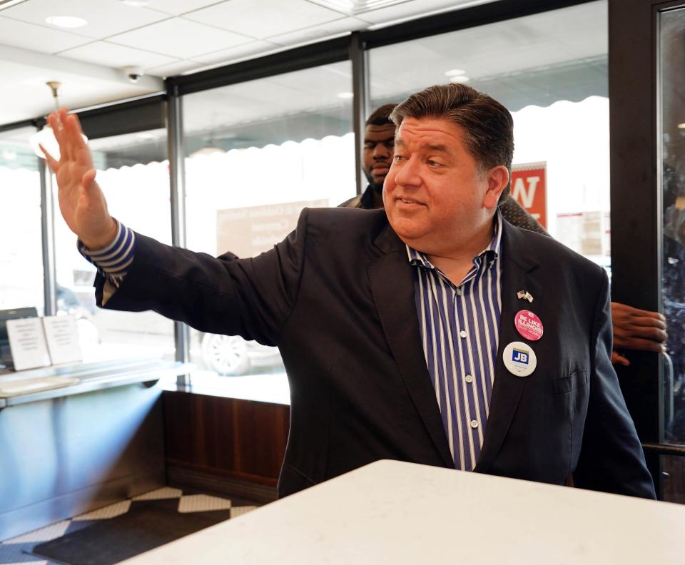 Gov. JB Pritzker waves while leaving Manny's Deli in Chicago, Tuesday, June 28, 2022.  Illinois Republicans on Tuesday will choose a nominee to take on  Pritzker, a billionaire who has spent millions trying to get the rival he wants and increase his already sizable advantage in the state this fall. (Kevin Tanaka /Chicago Sun-Times via AP)