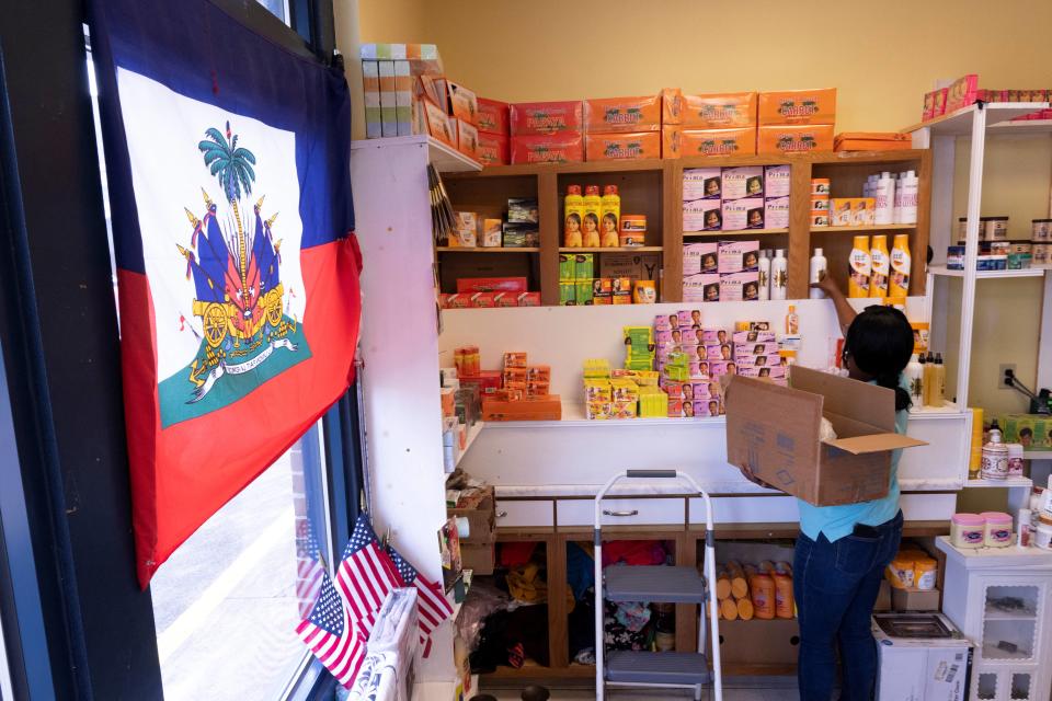 Creations Market shop owner Philomene Philostin, a naturalized US citizen of Haitian origin, shelves merchandise in her store that caters mainly to Haitian residents in Springfield, Ohio, on September 13, 2024. Bomb threats are being called into schools and businesses are closing at sundown in Springfield, Ohio, after the small US town has become the center of racist conspiracy theories targeting its Haitian immigrant community -- leaving some in fear for their lives. The mostly white city in the American Midwest has seen a boom in population in recent years, fueled mostly by Haitians attracted by its economic revival, and new businesses happy to attract laborers. (Photo by ROBERTO SCHMIDT / AFP) (Photo by ROBERTO SCHMIDT/AFP via Getty Images)