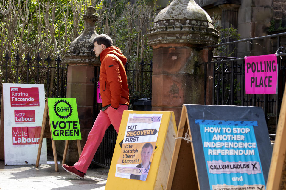A voter leaves a polling station in Edinburgh, Scotland, Thursday May 6, 2021. Polling stations across Britain have opened in what are considered to be the biggest-ever set of elections outside a general election. At stake are governments for Scotland and Wales, big city mayors, including for London and Manchester, as well as thousands of council members, police commissioners and other local authorities. (Lesley Martin/PA via AP)