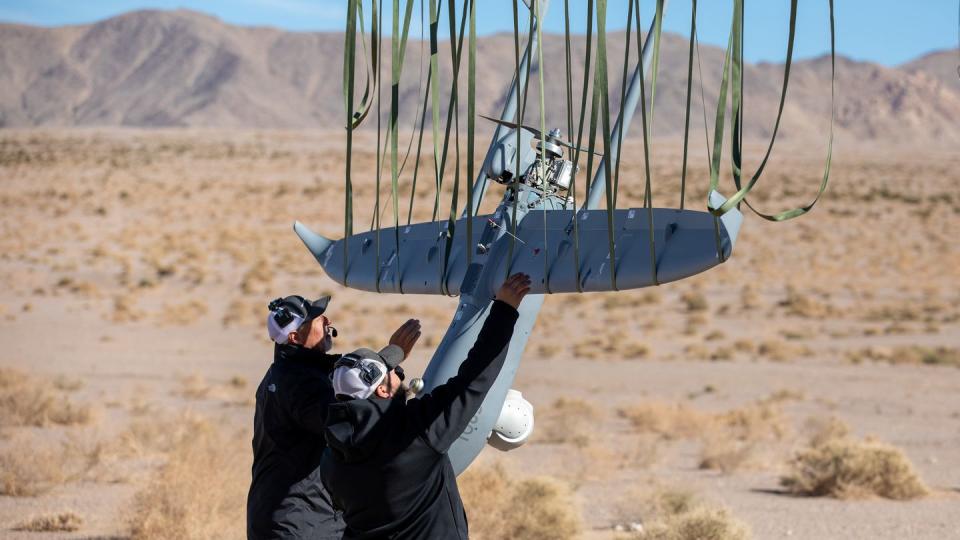 Military contractors extract a drone from a recovery net Nov. 4, 2022, at Fort Irwin, Calif. (Pfc. Samuel Brandon/U.S. Army)