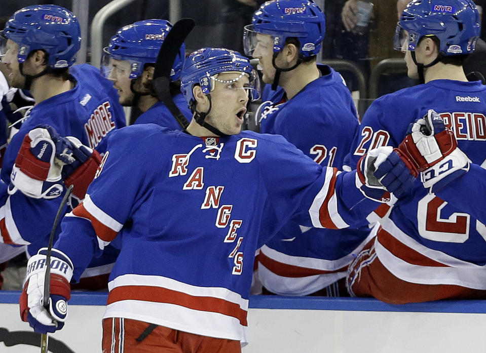 FILE - In this Feb. 4, 2014 file photo, New York Rangers' Ryan Callahan (24) celebrates with teammates after scoring a goal during the first period of an NHL hockey game against the Colorado Avalanche, in New York. The Rangers and Tampa Bay Lightning are pulling off the first major deal on NHL trade deadline day, Wednesday, March 5, 2014, swapping captains Ryan Callahan and Martin St. Louis.(AP Photo/Frank Franklin II)