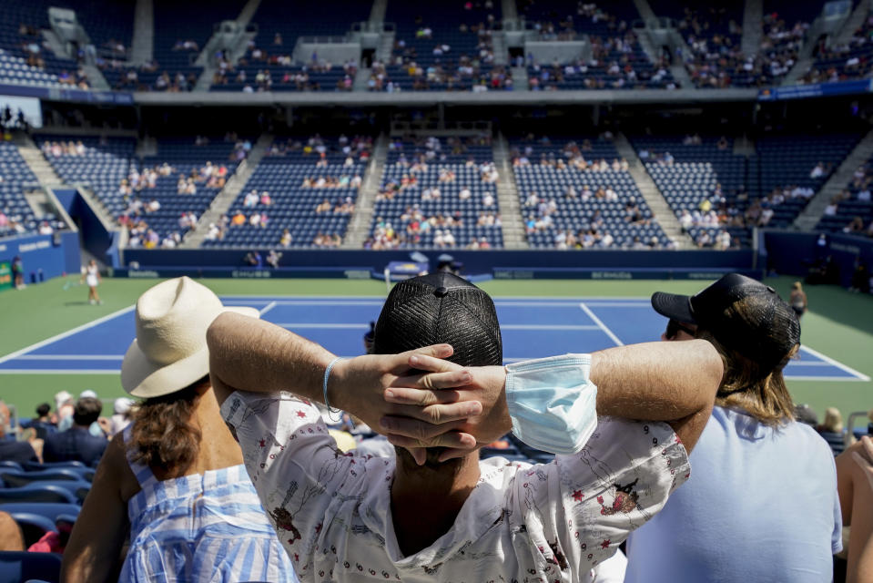 Tennis fans watch play between Karolina Pliskova, of the Czech Republic, and Catherine McNally, of the United States, during the first round of the US Open tennis championships, Tuesday, Aug. 31, 2021, in New York. (AP Photo/John Minchillo)