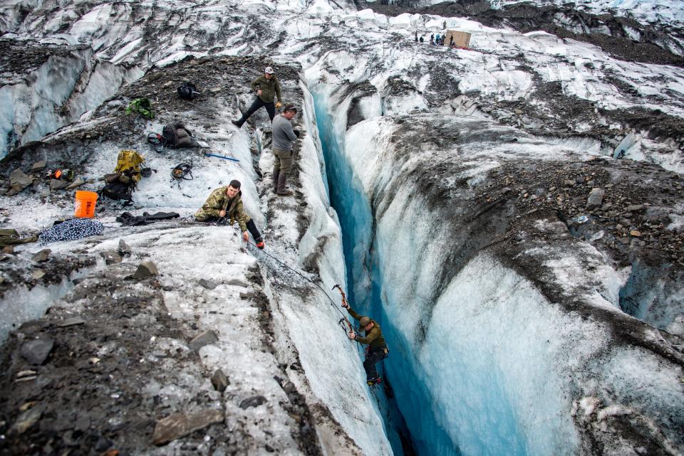 An Operation Colony Glacier recovery team member climbs out of a crevasse after searching the bottom for possible human remains, personal effects and equipment at Colony Glacier, Alaska, June 16, 2023. Operation Colony Glacier is an effort to recover the remains of service members and wreckage from a C-124 Globemaster II that crashed in November 1952 with 52 military members on board. The Department of Defense is deeply committed to bringing home those who were lost and providing their families and loved ones a sense of closure.