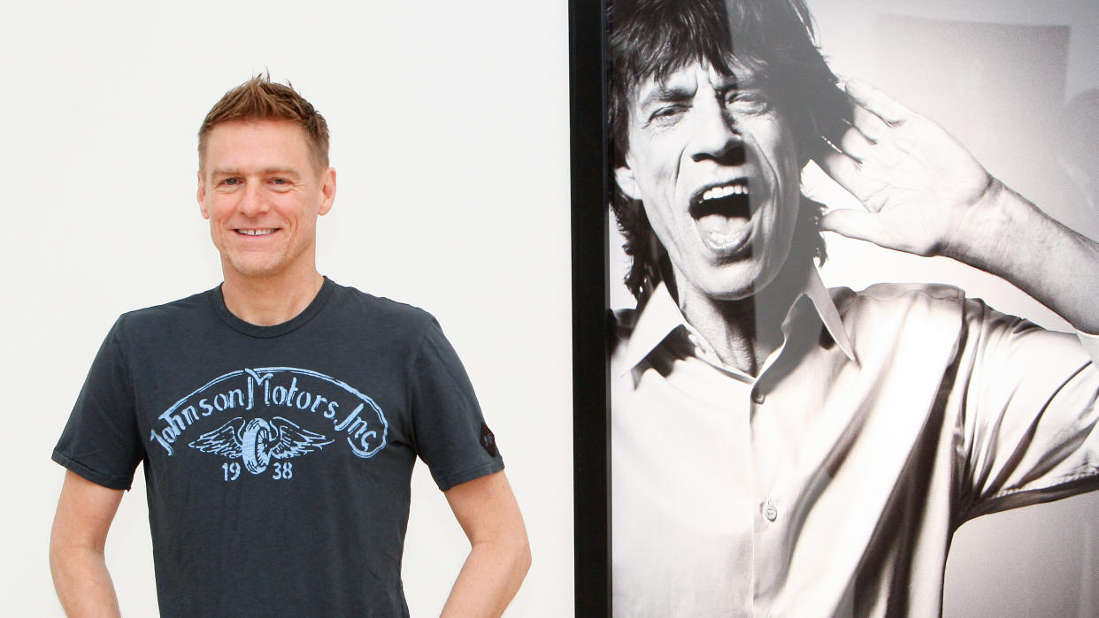  Musician and photographer Bryan Adams poses beside a portrait of Mick Jagger on display at his photography exhibition 'Hear The World Ambassadors' at Saatchi Gallery on July 21, 2009 in London, England. (Photo by Chris Jackson/Getty Images). 