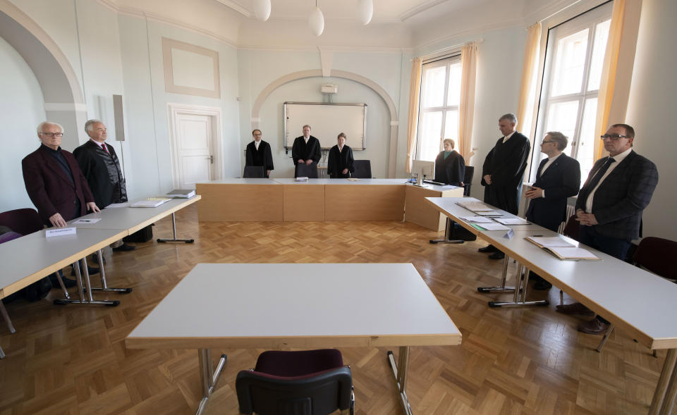 Volker Buchloh, Presiding Judge at Higher Regional Court, center, opens a trial at the Higher Regional Court in Naumburg, Germany, Tuesday, Jan. 21, 2020. The city of Wittenberg contains a Judensau (Jew-Pig) on the facade of the Stadtkirche (Town Church). The court will consider a Jewish man's bid to force the removal of an ugly remnant of centuries of anti-Semitism from a church where Martin Luther once preached. (AP Photo/Jens Meyer)