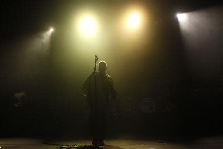 Black Francis of the American band the Pixies stands under stage lights during a performance at Lisbon Coliseum November 9, 2013. REUTERS/Hugo Correia