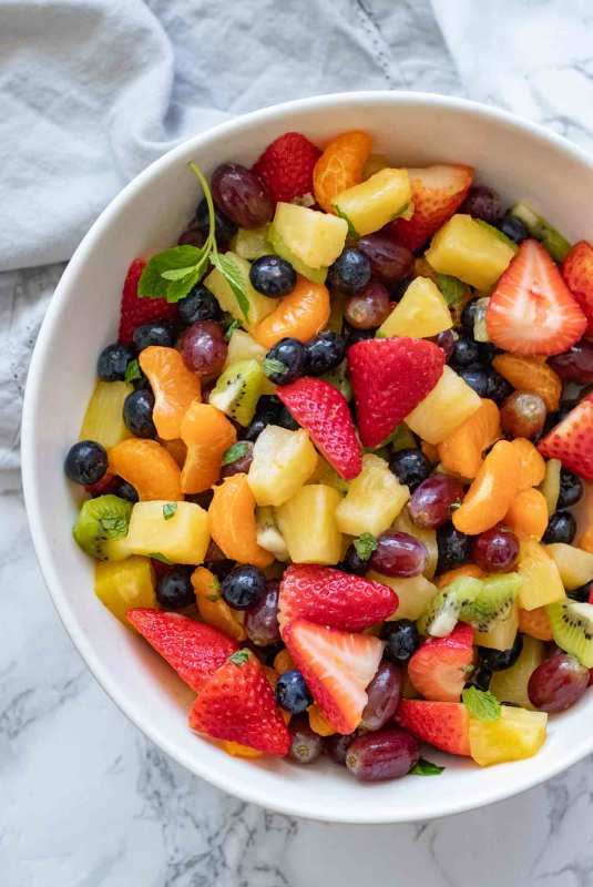 <p>Dinner Then Dessert</p><p>The perfect combo of berries, citrus fruit, kiwi, and grapes in a sweet sauce made from juice and honey and topped with fresh mint leaves.</p><p><strong>Get the recipe: <a href="https://dinnerthendessert.com/fruit-salad/" rel="nofollow noopener" target="_blank" data-ylk="slk:Easy Fruit Salad;elm:context_link;itc:0;sec:content-canvas" class="link ">Easy Fruit Salad</a></strong></p>