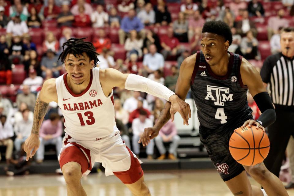 Mar 2, 2022; Tuscaloosa, Alabama, USA; Texas A&M Aggies guard Wade Taylor IV (4) drives to the basket around Alabama Crimson Tide guard Jahvon Quinerly (13) during the first half at Coleman Coliseum. Mandatory Credit: Butch Dill-USA TODAY Sports