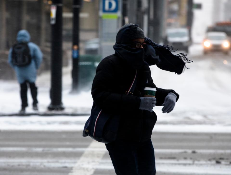 A Pedestrian walks through a winter storm on Wednesday, Jan. 30, 2019, in Downtown Cincinnati.