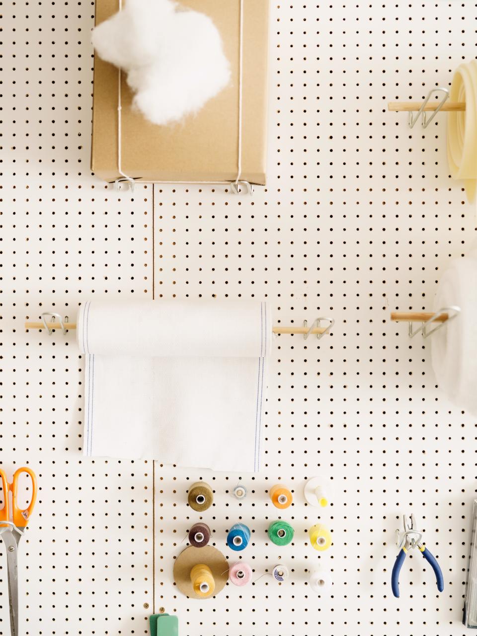 A pegboard holds Kurrein's sewing tools.