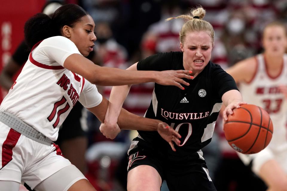 North Carolina State forward Jakia Brown-Turner (11) defends against Louisville guard Hailey Van Lith (10) during the first half of an NCAA college basketball game in Raleigh, N.C., Thursday, Jan. 20, 2022. (AP Photo/Gerry Broome)