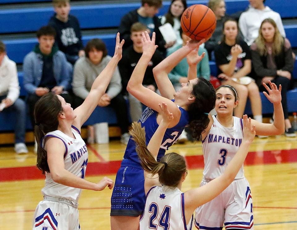 Northwestern High School's Kara McKay (24) shoots as Mapleton High School's Heidi Earl (12), Sara Hickey (3) and Kristen Flora (24) defend during high school girls basketball action on Tuesday, Jan. 18, 2022 at Mapleton High School. TOM E. PUSKAR/TIMES-GAZETTE.COM