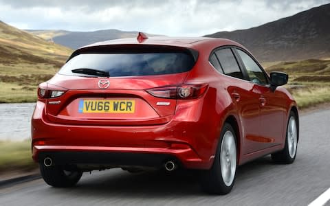 2017 Mazda3 driving rear 