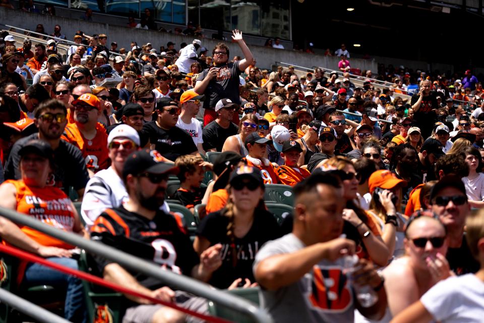 Cincinnati Bengals fans wave during the Cincinnati Bengals fan day practice at Paul Brown Stadium in Cincinnati on Saturday, July 29, 2023.