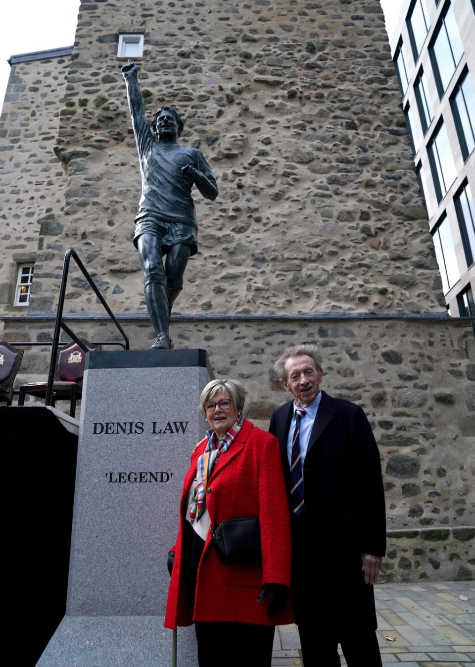 Denis Law and his wife Diana in front of the statue (Andrew Milligan/PA) (PA Wire)