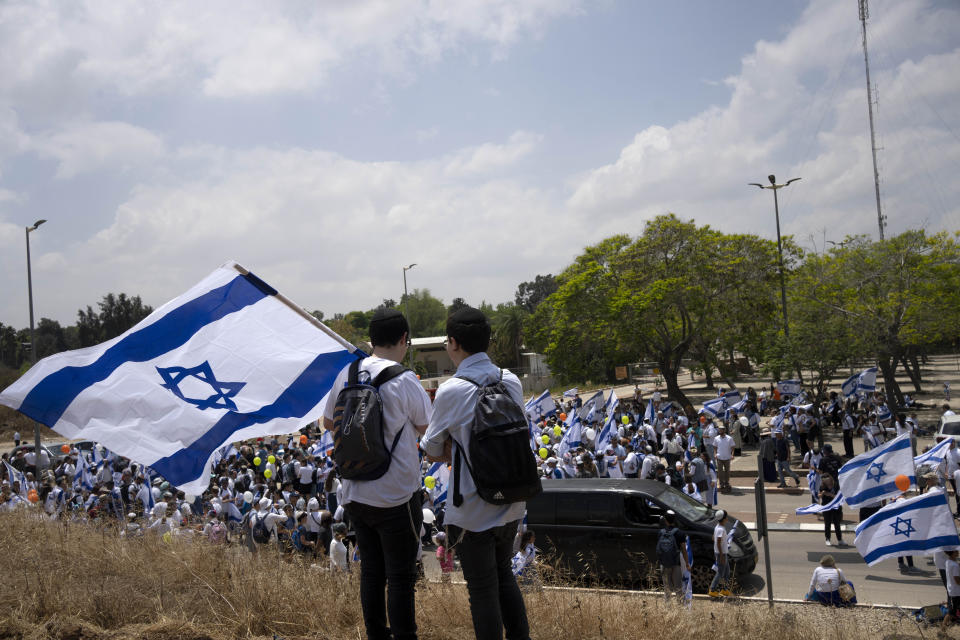 Thousands of Israelis march with national flags in the southern city of Sderot calling for Israel to reoccupy the Gaza Strip once the war is over, Tuesday, May 14, 2024. (AP Photo/Maya Alleruzzo)