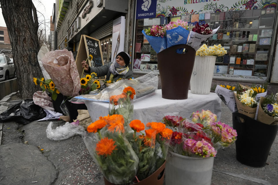 A street flower vendor prepares bouquets of flowers for sale in downtown Tehran, Iran, Thursday, Feb. 22, 2024. Candidates for Iran's March 1, parliamentary election began campaigning Thursday in the country's first election since the bloody crackdown on the 2022 nationwide protests that followed the death of 22-year-old Mahsa Amini in police custody. (AP Photo/Vahid Salemi)