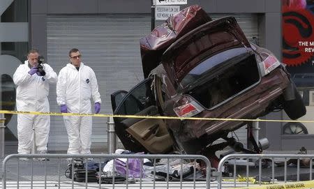 Police investigate the scene where a vehicle was driven onto a sidewalk and struck pedestrians in Times Square in New York, U.S., May 18, 2017. REUTERS/Lucas Jackson