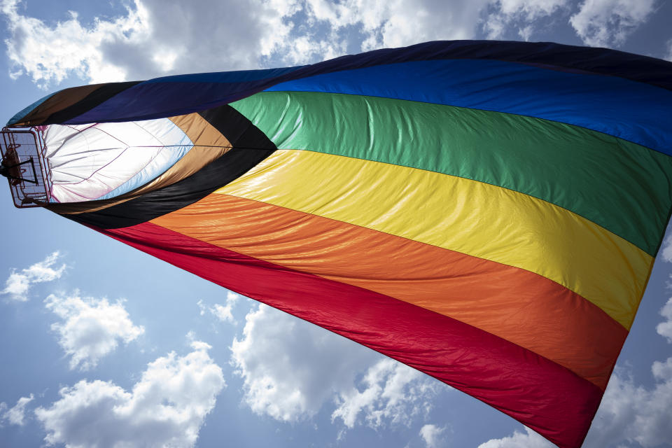 FILE - A Pride flag flies over the Franklin Pride TN festival Saturday, June 3, 2023, in Franklin, Tenn. On Friday, Sept. 22, The Associated Press reported on claims circulating online incorrectly claiming a video shows an angry parent tearing down a Pride flag draped over a U.S. map in a classroom. The video was staged. (AP Photo/George Walker IV, File)