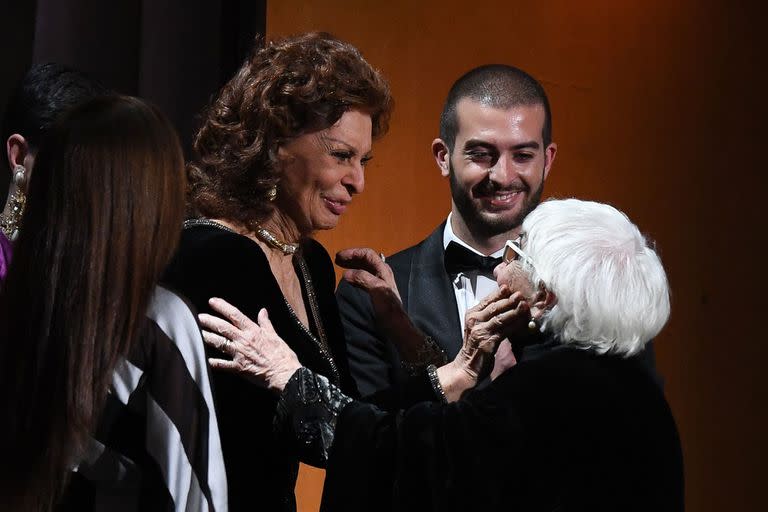 Italian director Lina Wertmuller is greeted by Sophia Loren onstage at the 11th Annual Governors Awards gala hosted by the Academy of Motion Picture Arts and Sciences at the Dolby Theater in Hollywood on October 27, 2019. (Photo by Valerie MACON / AFP)