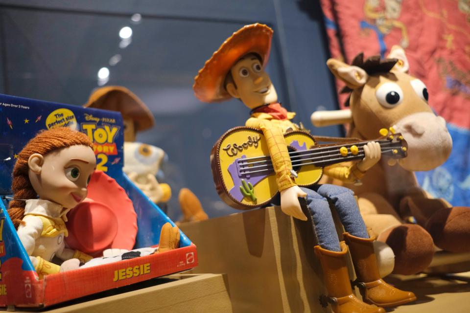 A variety of "Toy Story" items are displayed in the National Cowboy & Western Heritage Museum exhibit "Playing Cowboy" Friday, March 24, 2023, in Oklahoma City. Featuring Western costumes, games and toys for children, "Playing Cowboy" is on view through May 7 at the OKC museum.