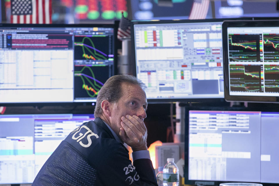 Specialist Glenn Carrel works at his post on the floor of the New York Stock Exchange, Wednesday, Aug. 14, 2019. Stocks are falling sharply after the bond market threw up another warning flag on the economy. (AP Photo/Richard Drew)