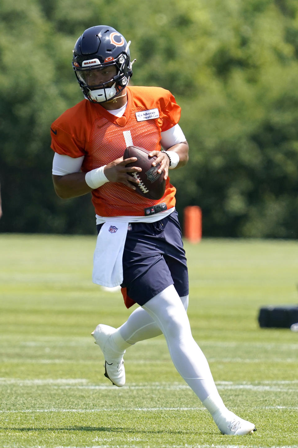 Chicago Bears quarterback Justin Fields runs with a ball during NFL football practice in Lake Forest, Ill., Wednesday, June 9, 2021. (AP Photo/Nam Y. Huh)