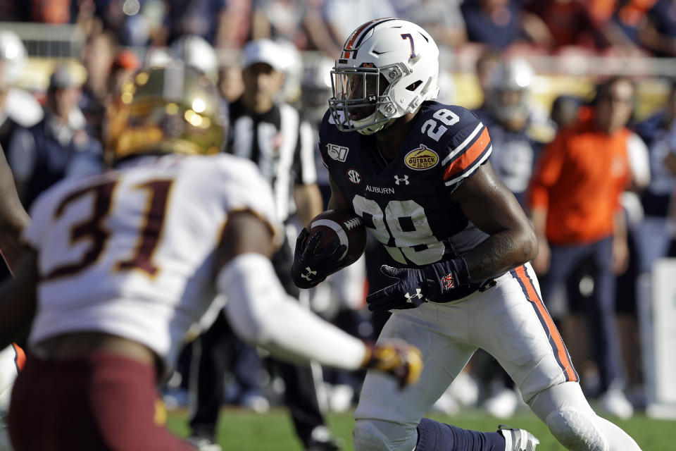 Auburn running back JaTarvious Whitlow (28) scores on a 3-yard touchdown run against Minnesota during the second half of the Outback Bowl NCAA college football game Wednesday, Jan. 1, 2020, in Tampa, Fla. (AP Photo/Chris O'Meara)