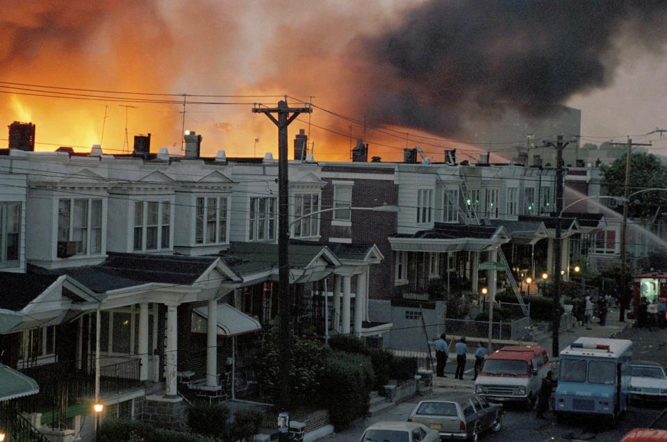 <p>Scores of row houses in Philadelphia burned and 11 people were killed after police dropped two bombs on a home belonging to radical Black liberation organisation MOVE on 13 May, 1985.</p> (AP)