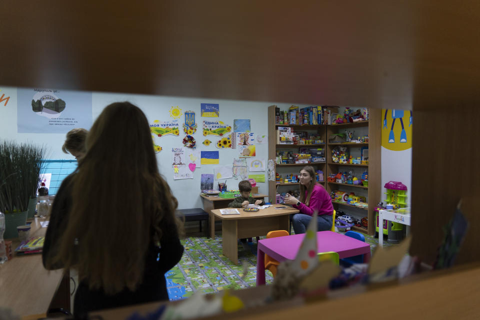 A child from Mariupol plays at the library in Dnipro, Ukraine, on Nov. 22, 2022. The library has been transformed into a center for refugees from Mariupol since the city's capture by Russian forces in the spring. (AP Photo/Vasilisa Stepanenko)