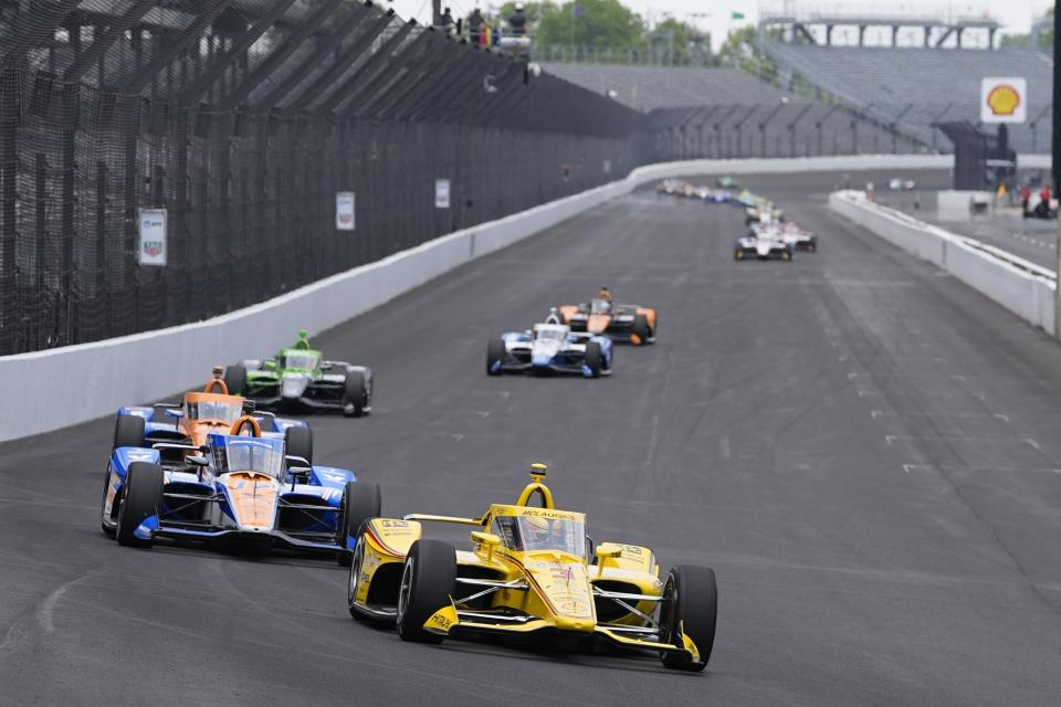 Scott McLaughlin, of New Zealand, leads a group of cars into a turn during a practice session for the Indianapolis 500 auto race at Indianapolis Motor Speedway, Monday, May 20, 2024, in Indianapolis. (AP Photo/Darron Cummings)