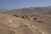 Homes at the Palestinian hamlet during the European Union representatives visit to the school structure that is under the threat of demolition by the Israeli authorities, in the West Bank Bedouin community of Ein Samia, northeast of Ramallah, Friday, Aug. 12, 2022. The Israeli District Court in Jerusalem issued on Wednesday a decision to immediately demolish the Ein Samia school. Fifty four schools serving seven thousand Palestinian children in the West Bank's area "C" are under threat of demolition, Sven Kühn von Burgsdorff, the European Union's representative to the West Bank and Gaza told reporters. (AP Photo/Nasser Nasser)