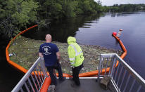 <p>Activist Rocky Morrison, left, and volunteer Dalton Abbott, of the “Clean River Project” examine a boom filled with waste collected from a recovery boat on the Merrimack River in Chelmsford, Mass. Syringes left by drug users amid the heroin crisis are turning up everywhere. They hide in weeds along hiking trails and in playground grass, get washed into rivers and onto beaches, and lie scattered about in baseball dugouts and on sidewalks and streets. There are reports of children finding them and getting poked. (Photo: Charles Krupa/AP) </p>