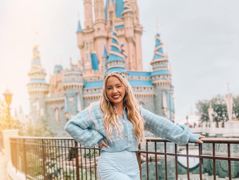 kayleigh posing in front of the castle at disney world