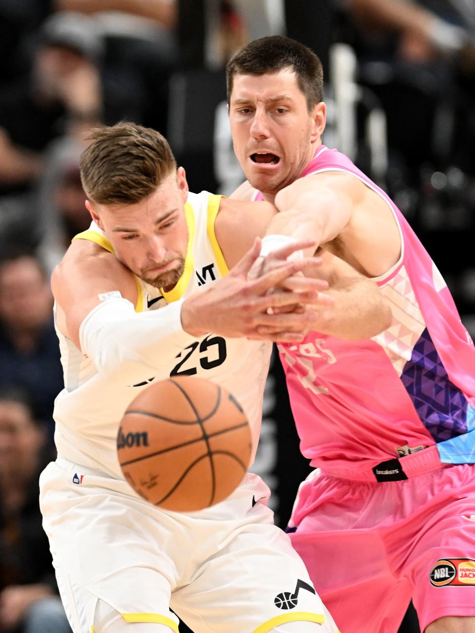 Utah Jazz center Micah Potter (25) fights to regain the ball as Breakers’ forward Dane Pineau (22) hits it away as the Utah Jazz and the New Zealand Breakers play at the Delta Center in Salt Lake City on Monday, Oct. 16, 2023. Jazz won 114-94. | Scott G Winterton, Deseret News